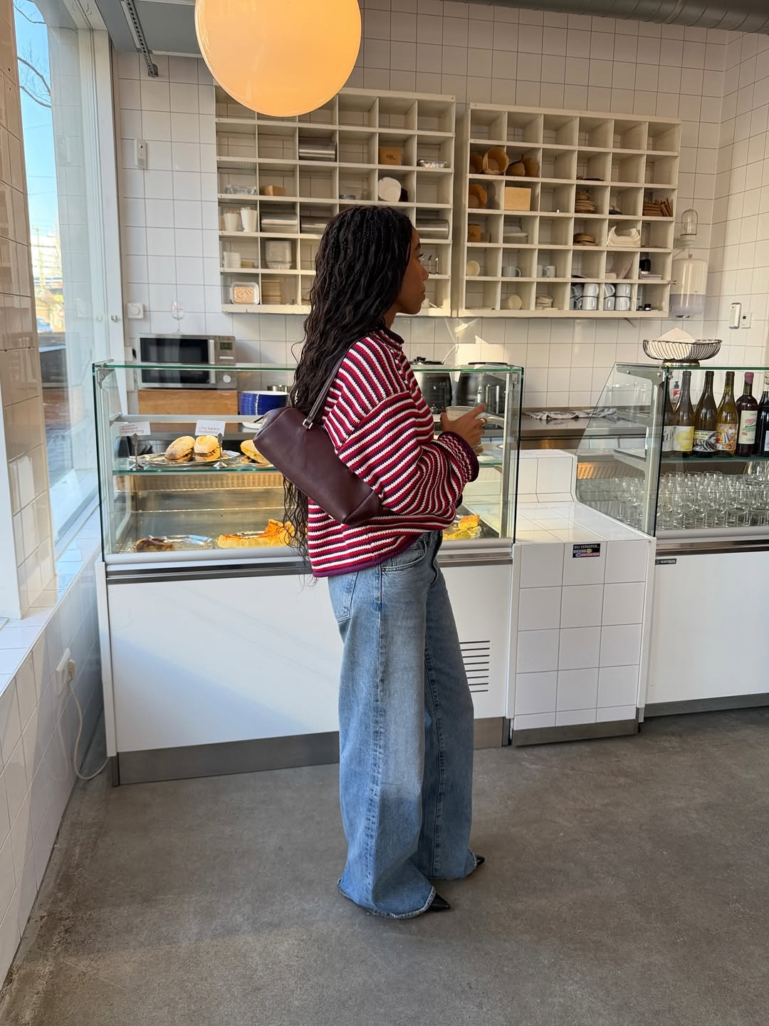 An image of a woman wearing sun faded jeans, a major denim trend 2026.