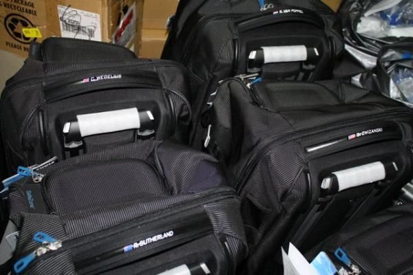 The bags are labelled with the riders' names.