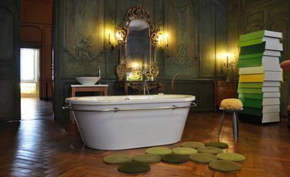 White bath tub with wooden flooring 