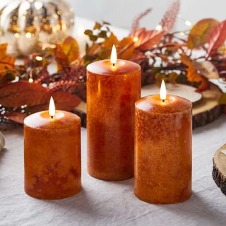 Lights4fun autumn collection pillar candles on table with autumn leaves 
