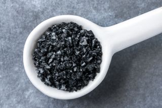 A white tablespoon of activated charcoal