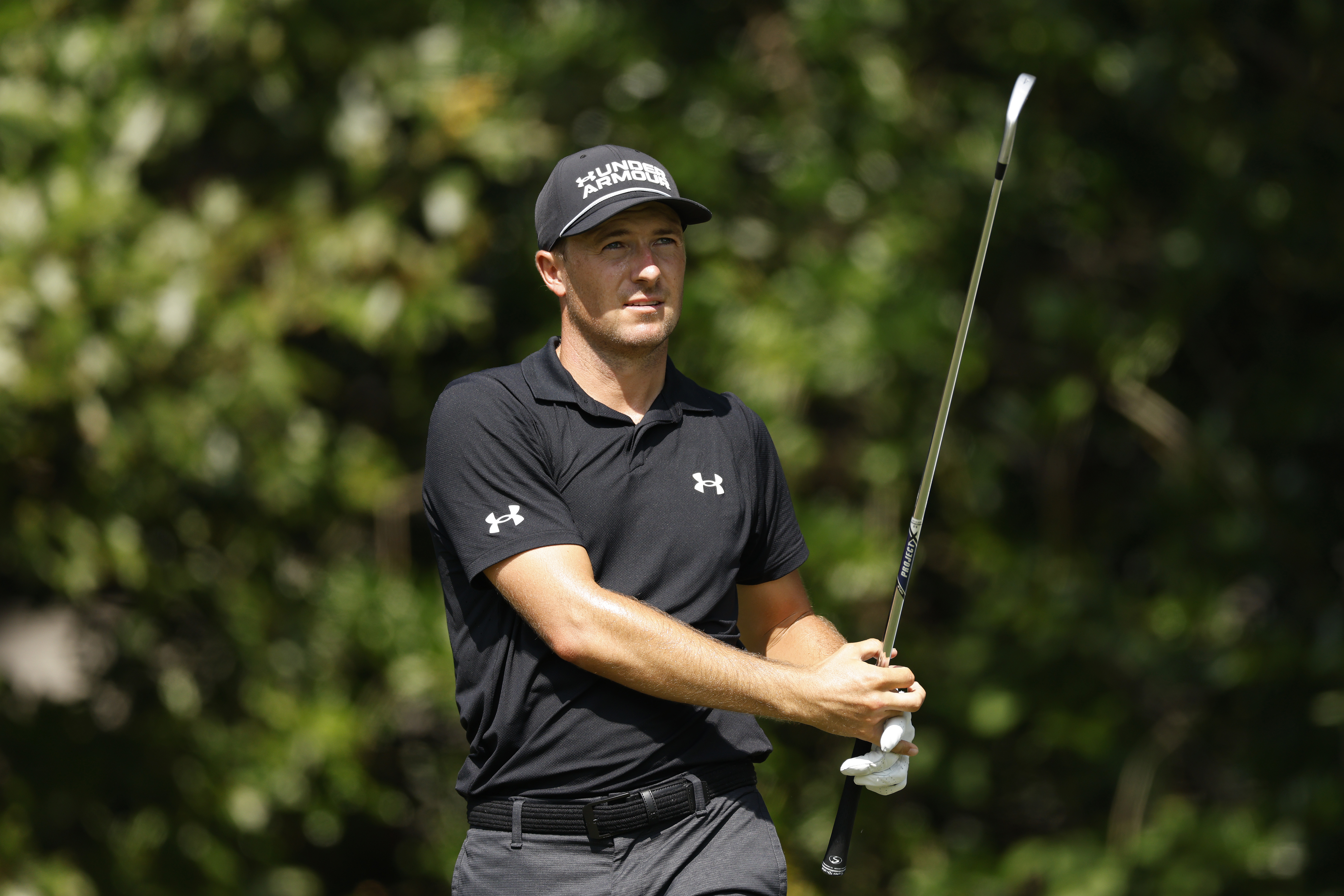 Jordan Spieth hits an iron shot and watches its flight