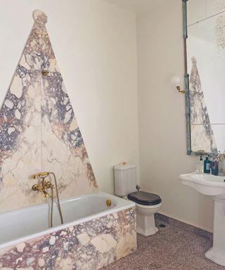 Bathroom with triangular backsplash in marble