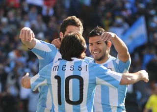 Argentina's striker Lionel Messi (C) celebrates with Argentina's striker Gonzalo Higuain (L) and Argentina's striker Sergio Aguero after Higuain scored his third goal of the match during their Group B first round 2010 World Cup football match on June 17, 2010 at Soccer City stadium in Soweto, suburban Johannesburg. 