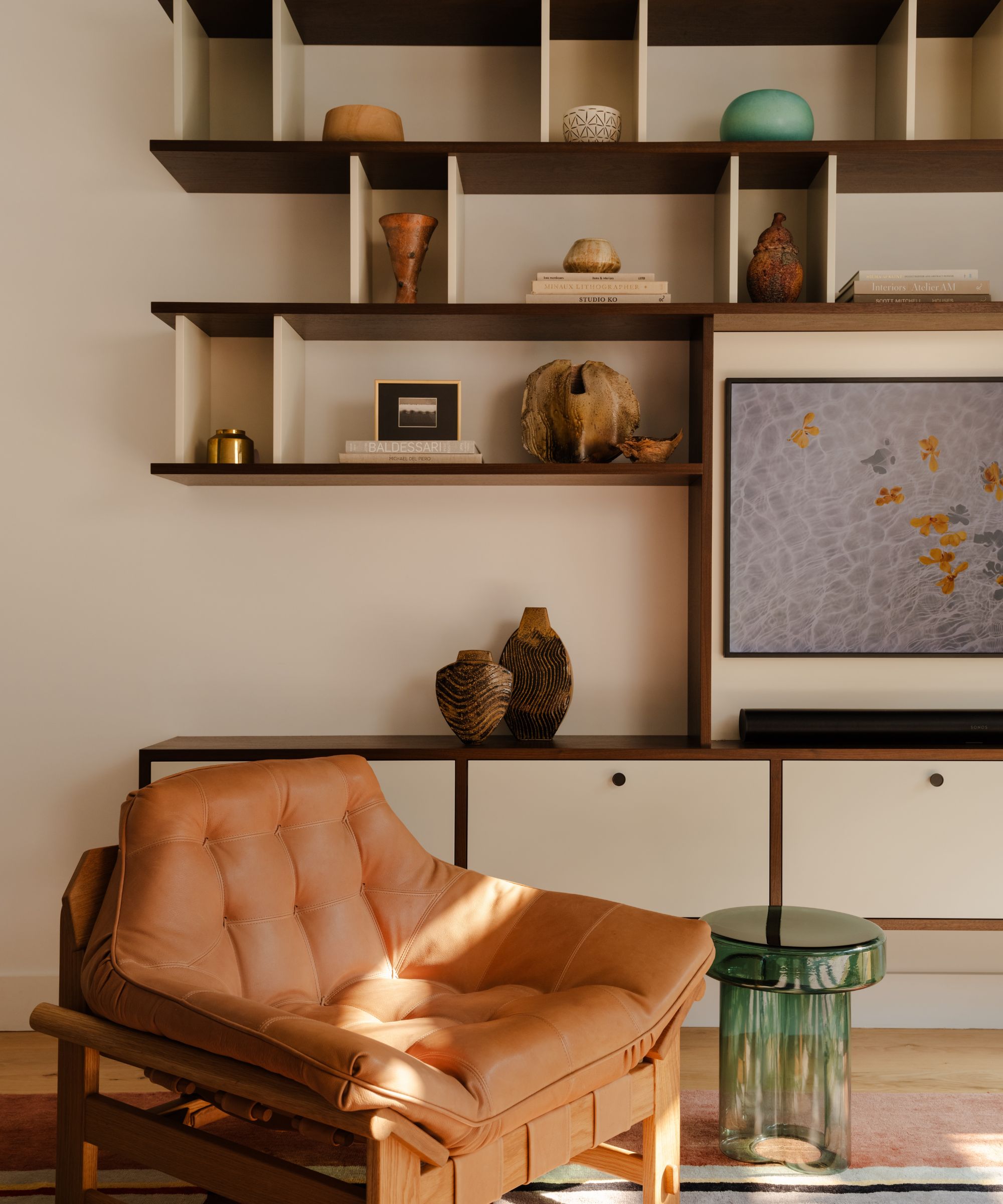 living room with shelf unit and leather armchair