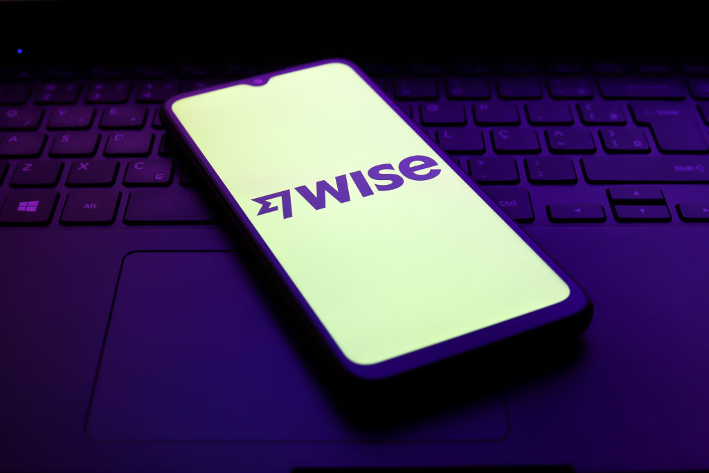 The Wise logo appears on the screen of a smartphone