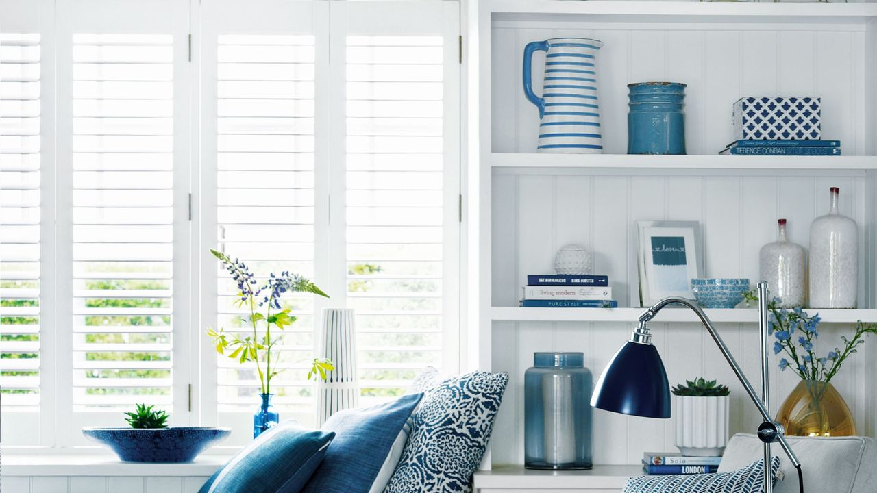 Living room with blue accents, window with window blinds, daybed