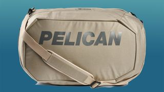 The Pelican AEGIS Series Duffel Pack (Sand, 45L) on a blue to green gradient