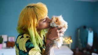 Woman kissing guinea pig