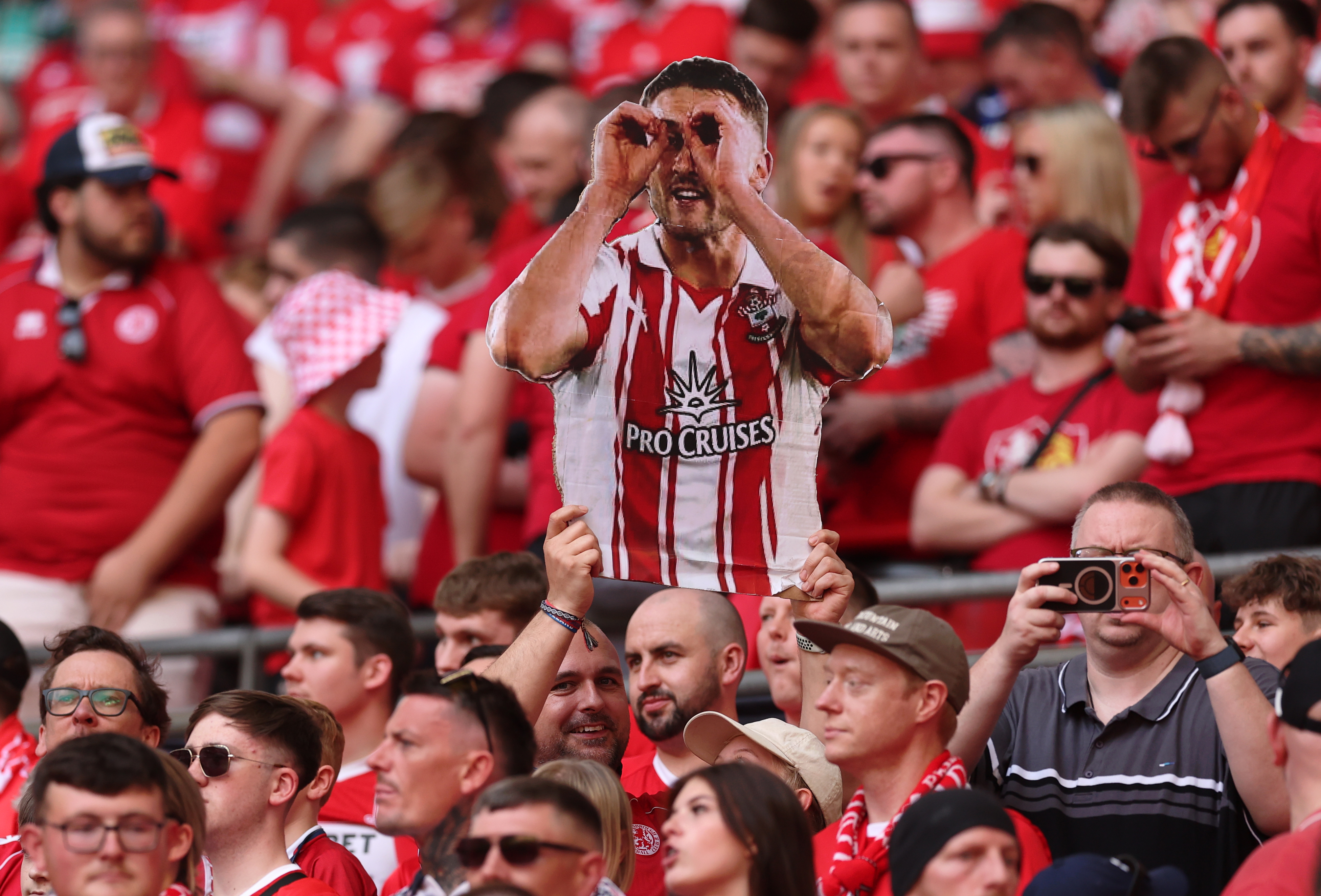A Middlesbrough fan holds a cardboard cut-out of Southampton defender Taylor Harwood-Bellis