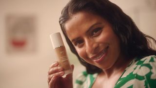 Anita, a real woman who loved using no7 serum foundation holding the foundation bottle