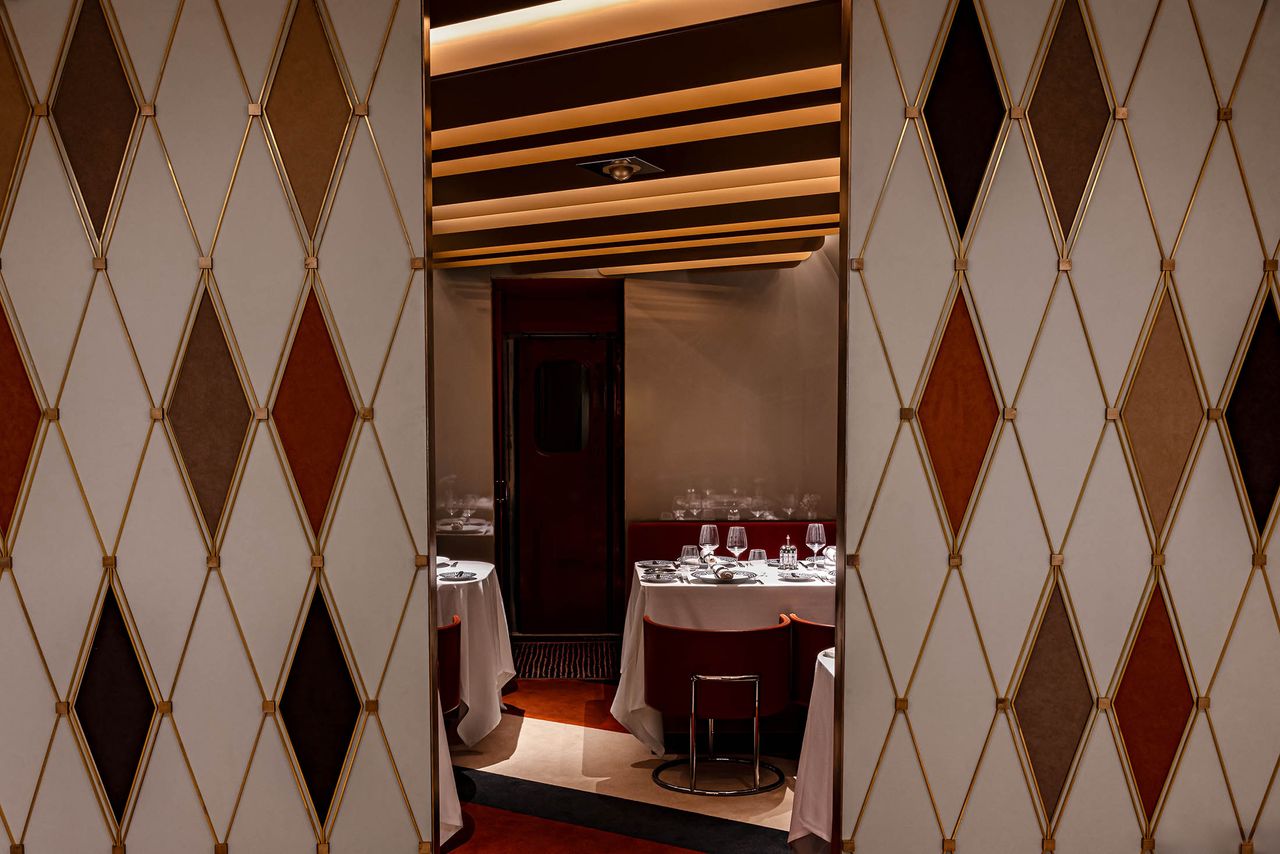 A 1980s-inspired luxury train features sleek decor.