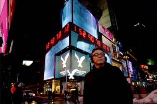 Artist Marco Brambilla in front of one of more than a dozen screens that are part of his Times Square art piece, "Apollo XVIII," which combines archival NASA footage with new digital images
