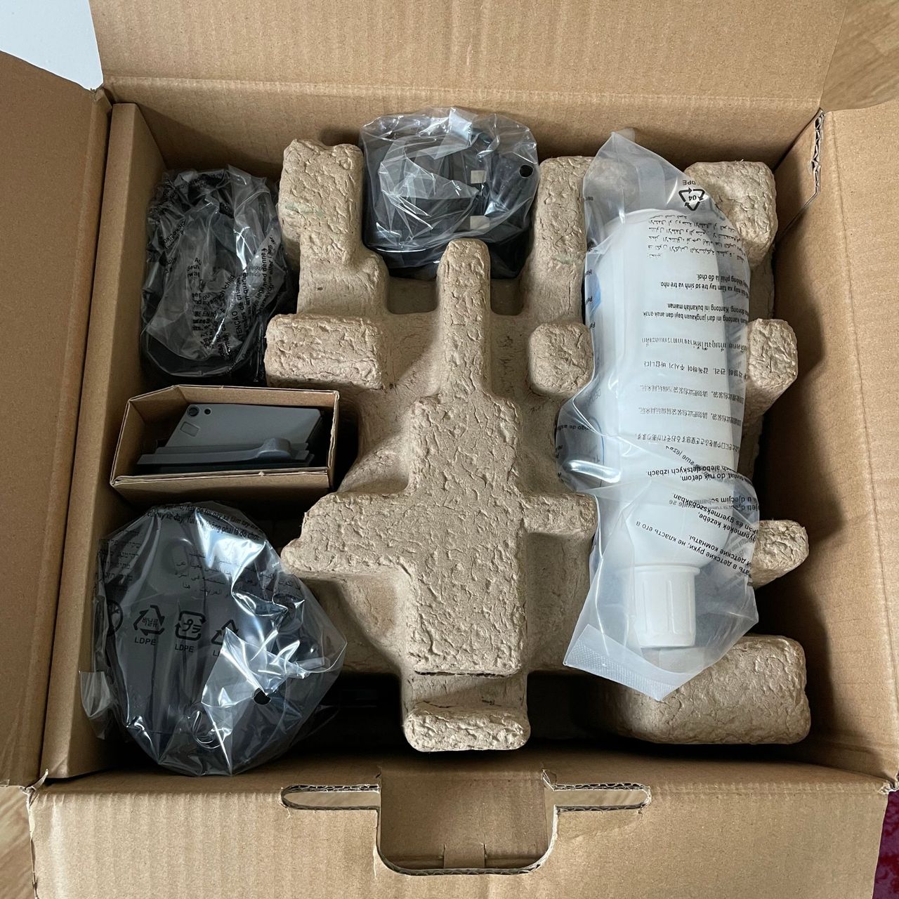 Looking inside the box of the Tineco FLOOR ONE S5 Smart Mop where all of the components are encased in cardboard or plastic