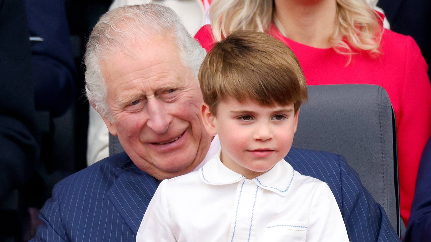 Prince Louis sits on his grandfather King Charles's lap as they attend the Platinum Pageant on The Mall on June 5, 2022