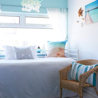 guest room with white bedding and turquoise blinds