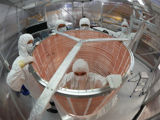 Members of the Xenon Collaboration prepare their dark matter detector, which is filled with 3.5 tons (3,200 kilograms) of liquid xenon. Though the group has found no traces of dark matter yet, they did detect the second-longest radioactive decay in the universe.