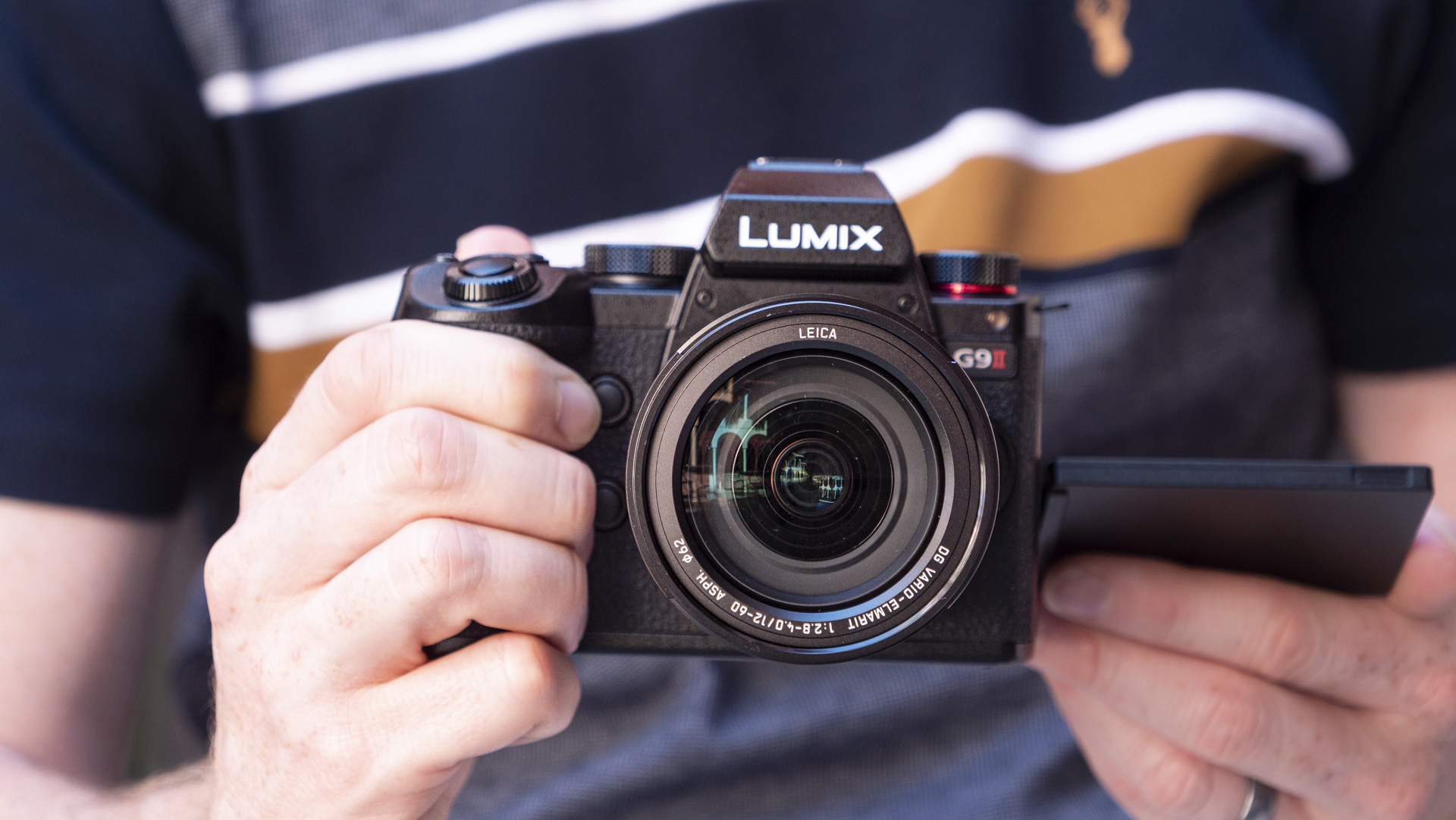 Panasonic Lumix G9 II camera on a patterned table with pink flower background