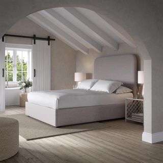 Grey upholsterd bed frame in grey bedroom