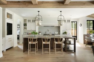 A kitchen with transitional style lighting