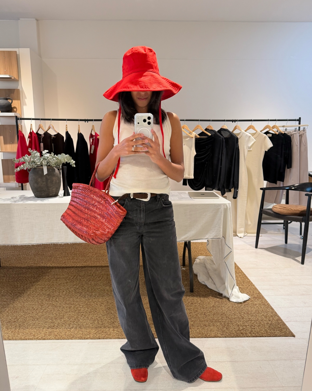 Cathy Karuga wearing a red summer hat.