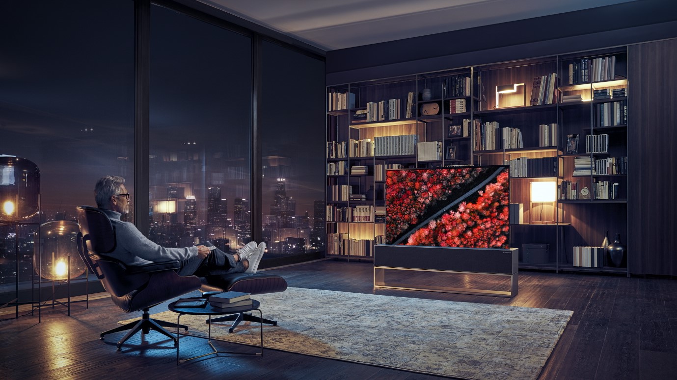 LG Signature RX 'Rollable' OLED in a dark but stylish living room with massive windows nearby