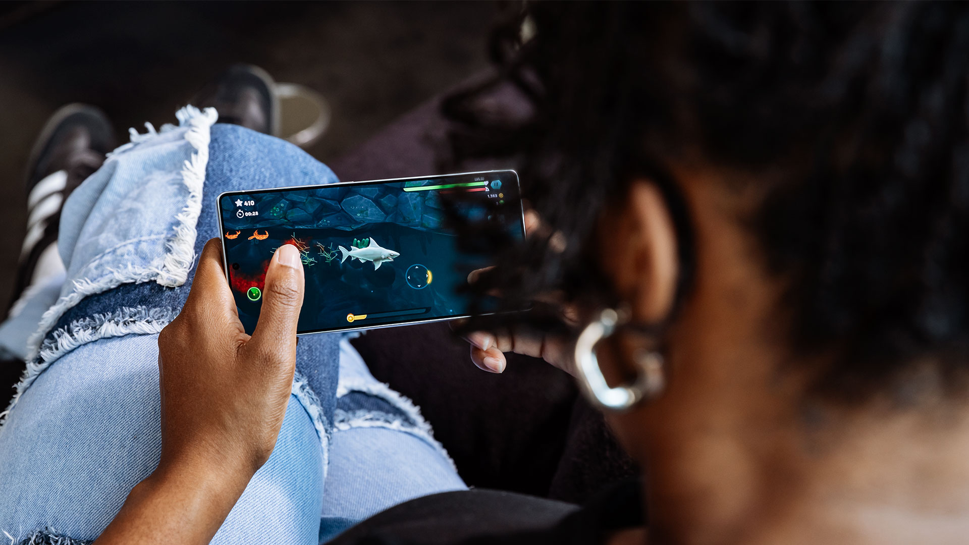 A woman plays a shark game on the Samsung Galaxy S25