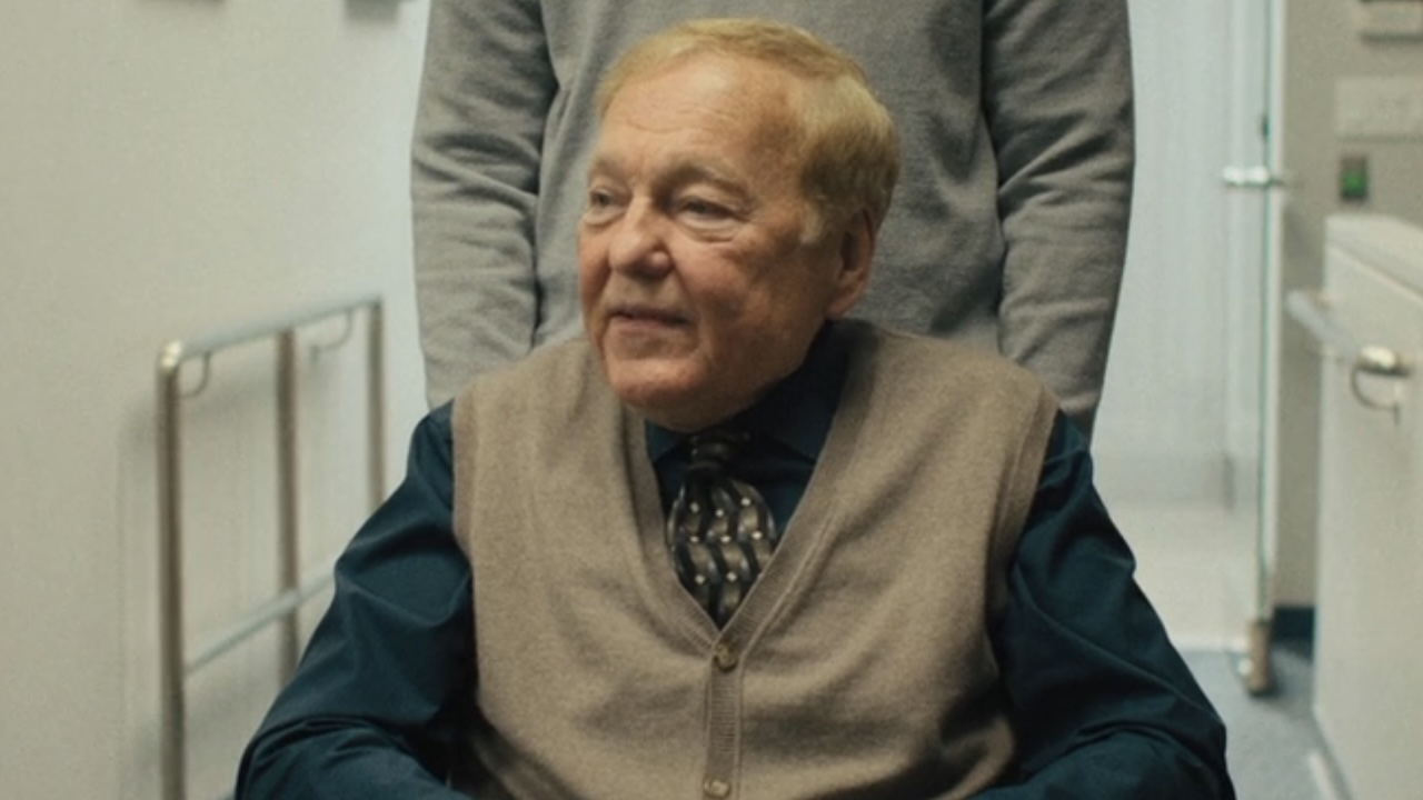 Douglas in wheelchair speaking to co-workers in The Chair Company Season 1