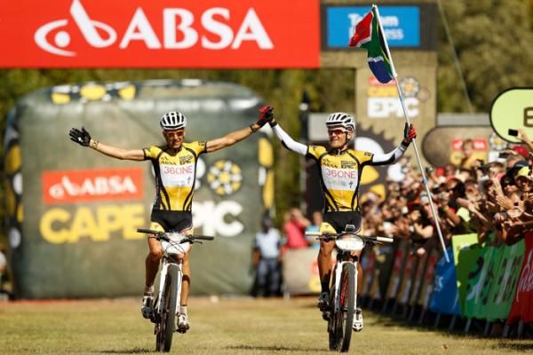 Christoph Sauser and Burry Stander of 36One-Songo-Specialized celebrate during the final stage