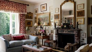 an interior view of someone's living room including a large mirror and lots of photos