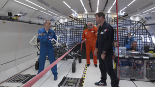 ESA chief astronaut trainer Hervé Stevenin and astronaut Thomas Pesquet during experiments with the LESA lunar wheelbarrow during a parabolic flight simulating lunar gravity.