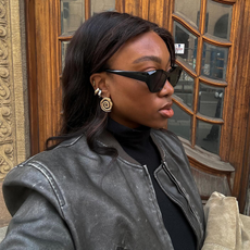 Nnenna Chem in black cat-eye sunglasses and gold jewelry.