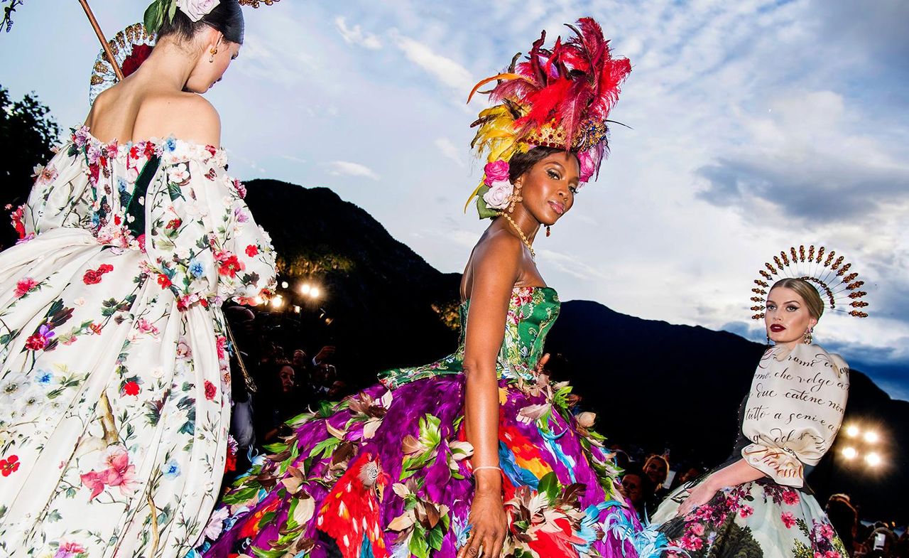 Fashion model wearing a colour full dress and head piece 