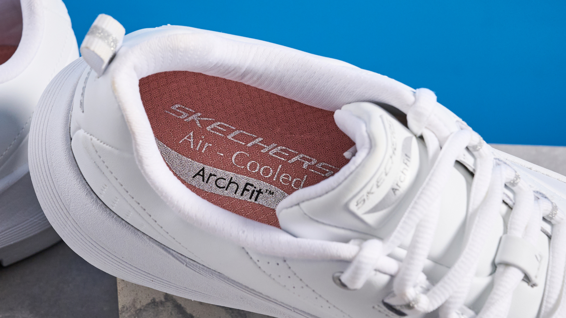 Skechers Arch Fit 2.0 Star Bound photographed in front of a blue background.
