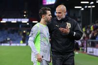 BURNLEY, ENGLAND - APRIL 22: Josep 'Pep' Guardiola, head coach of Manchester City, speaks with Bernardo Silva of Manchester City during the Premier League match between Burnley and Manchester City at Turf Moor on April 22, 2026 in Burnley, England. (Photo by James Gill - Danehouse/Getty Images)