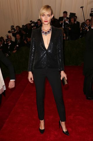 Amber Valletta Wears A Black Smoking Jacket And Trousers By Saint Laurent