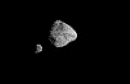 two grey rocks tumble in space