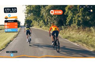 This image shows what the Rouvy Strava Live Segment would look like to a user, with two animated 3D riders overlaid on a real life background