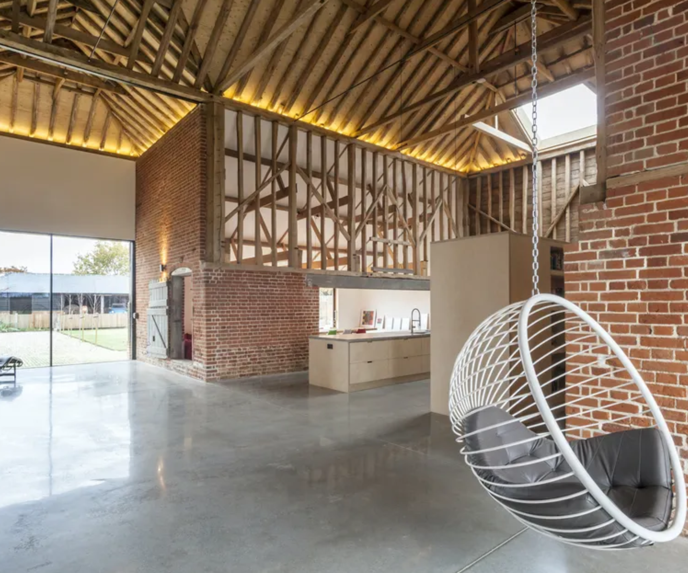 concealed lighting around the timber beams of a barn conversion
