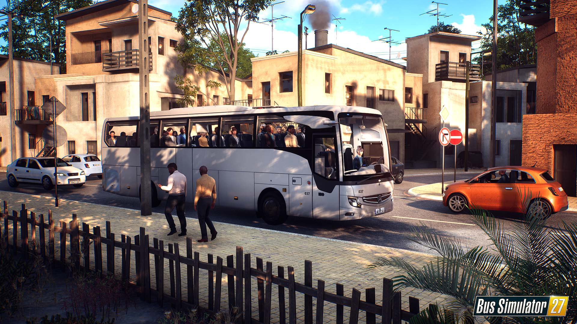 A promotional render for Bus Simulator 27 that shows a white bus parked at the side of the road in a fictional southern European town. 