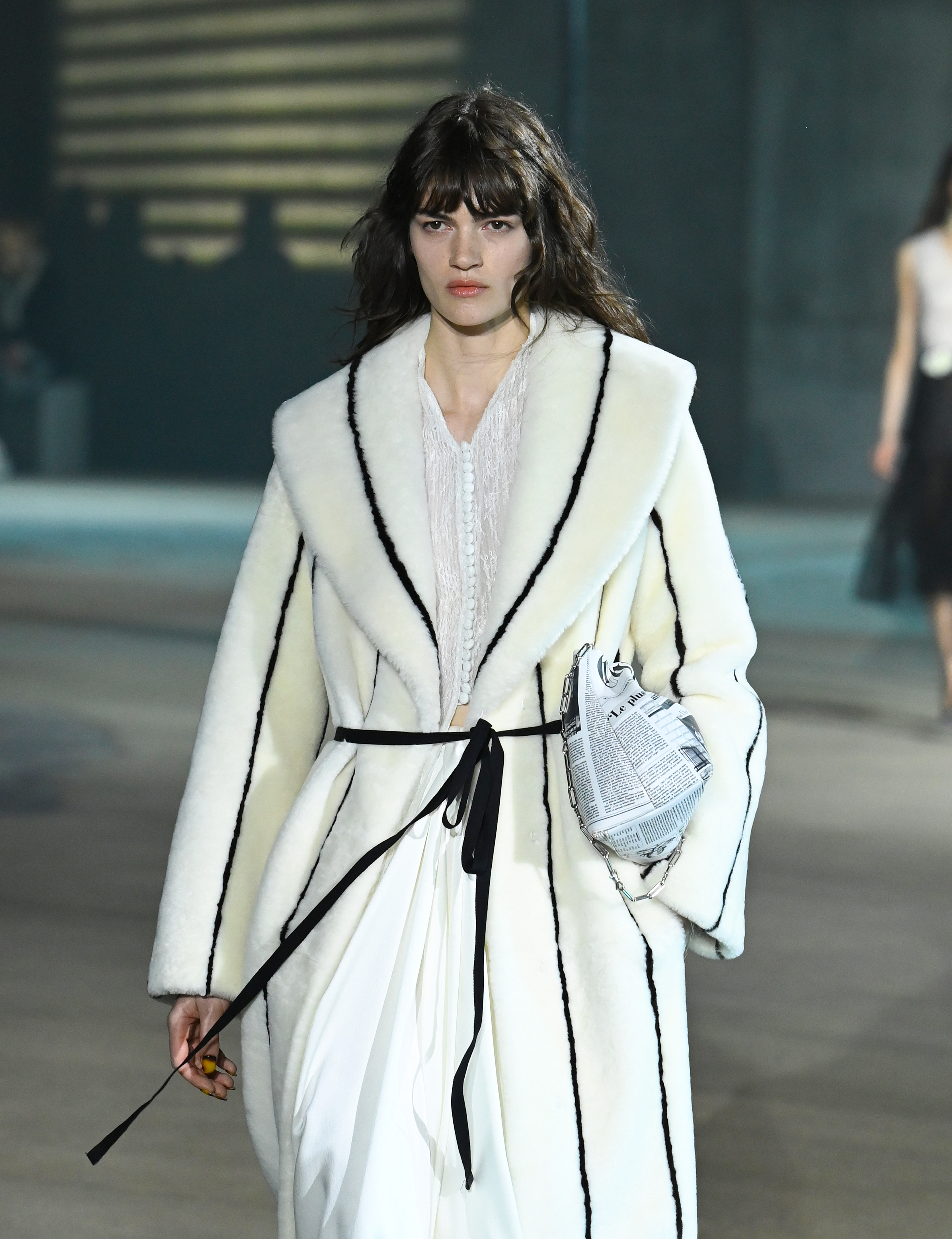 A model wore Dior's newspaper print on the Cruise 2027 runway