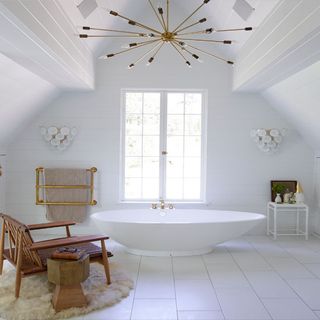 bathroom with bathtub and white tiled flooring