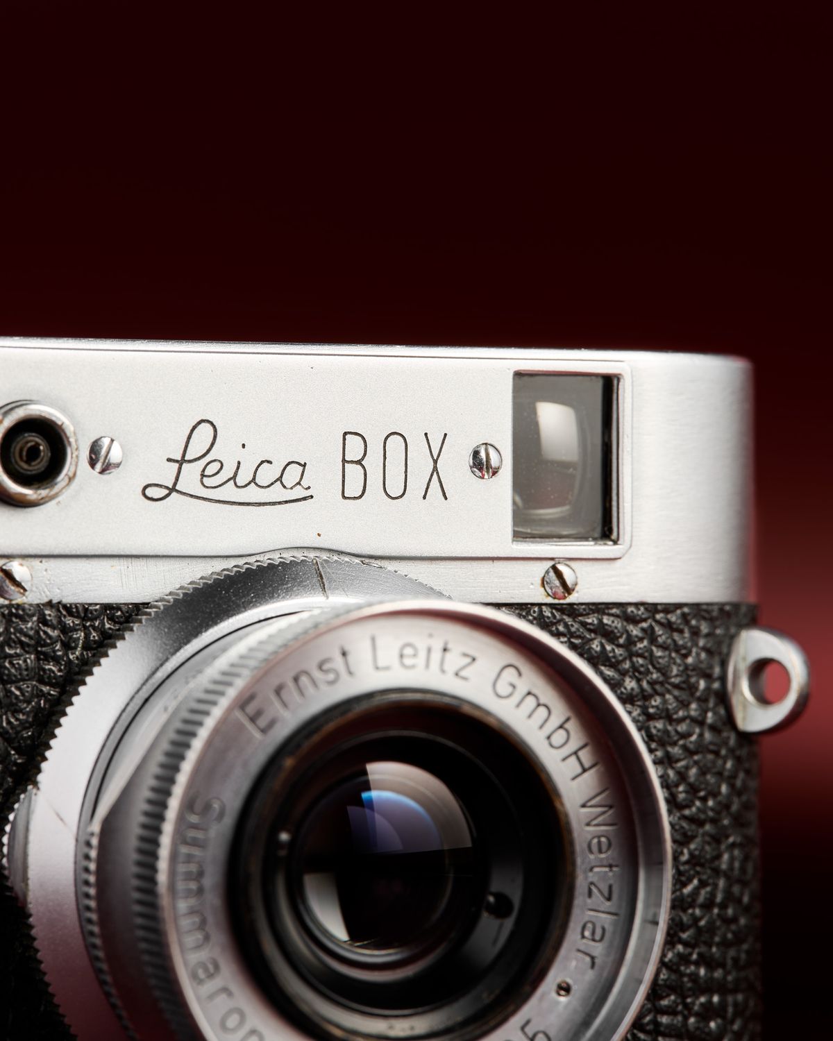 The working Leica Box camera prototype from the mid 1950s on a red background