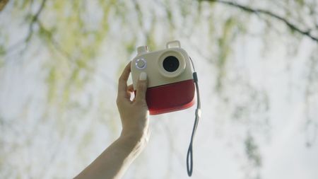 A hand holding up the Poetry Camera