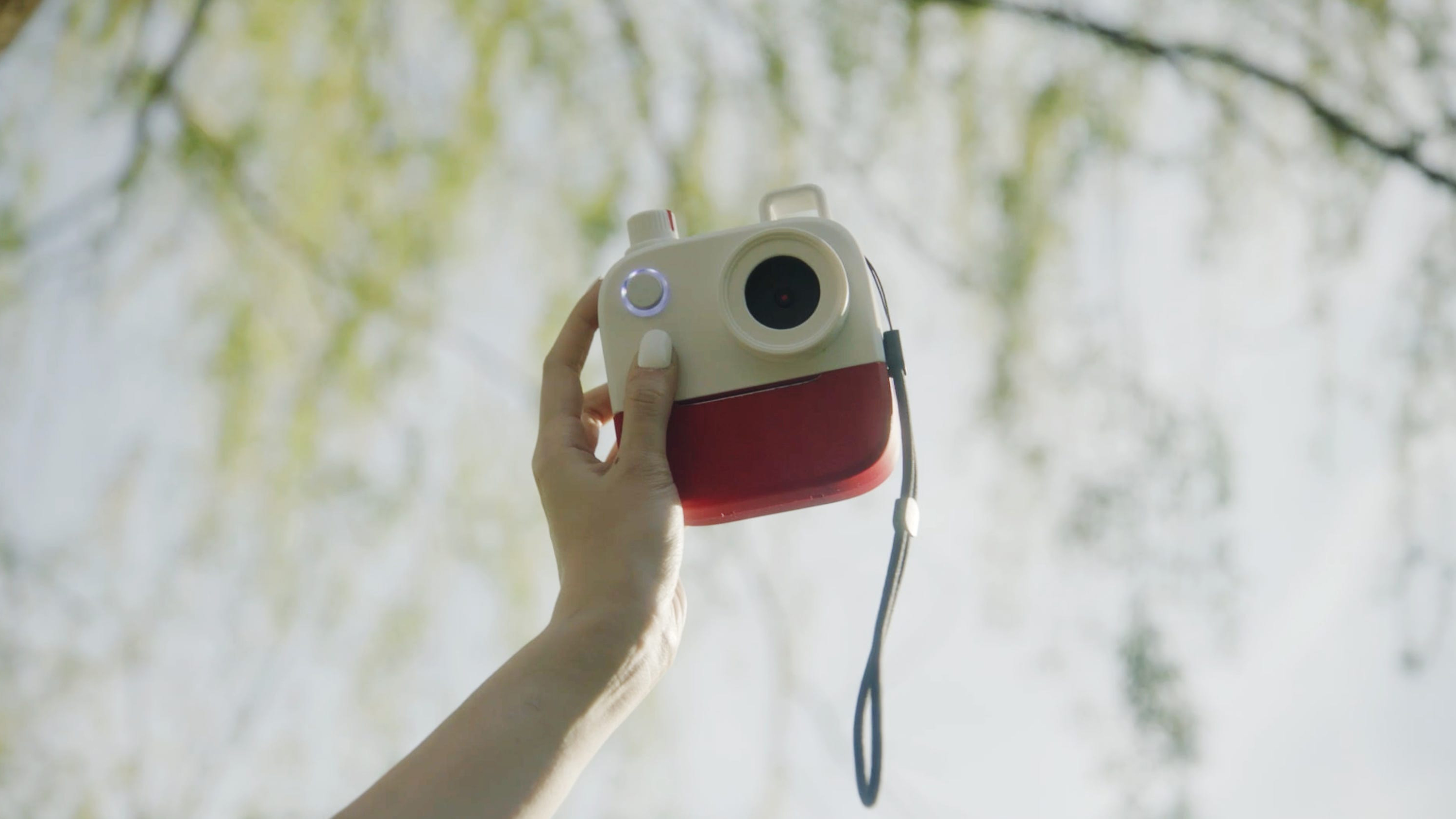 A hand holding up the Poetry Camera