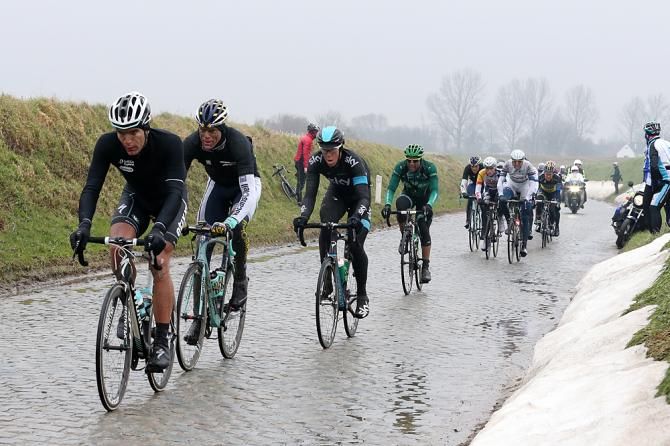 Snow blankets the verges on the cobbles in Dwars door Vlaanderen
