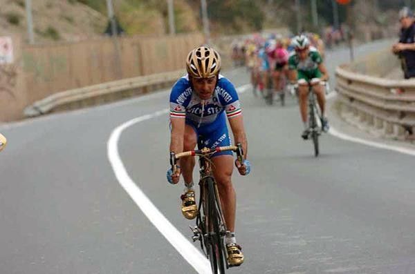 Paolo Bettini (Quick.Step) attacks, resplendent (is there any other word you can use?) in his Olympic gold helmet and bike.