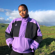 @champagnemani wearing a purple and black windbreaker