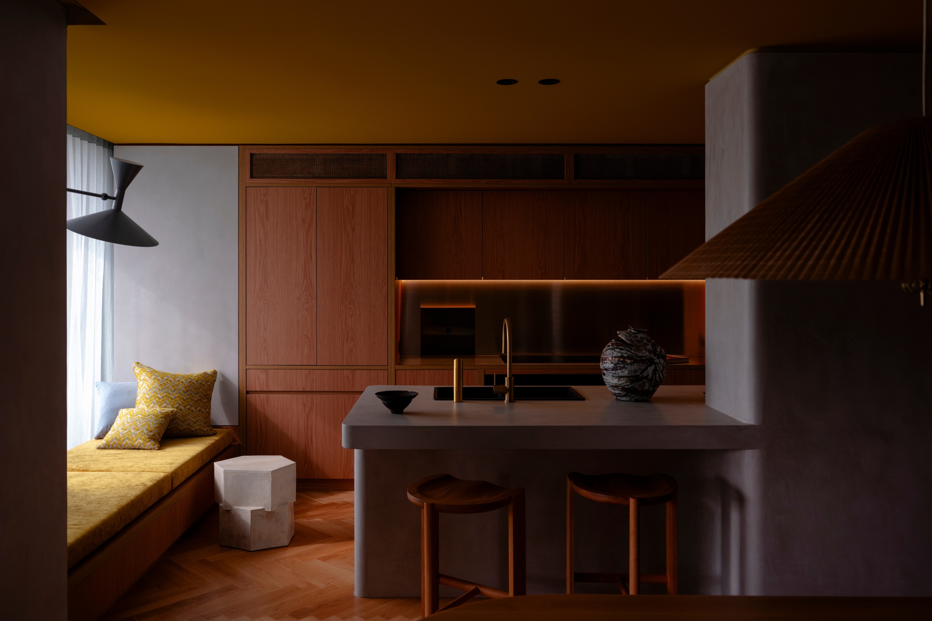 Wood kitchen with ochre ceiling by Studio Prineas