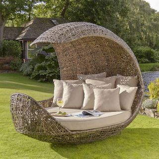 double daybed in garden with cushion trees and garden with pool